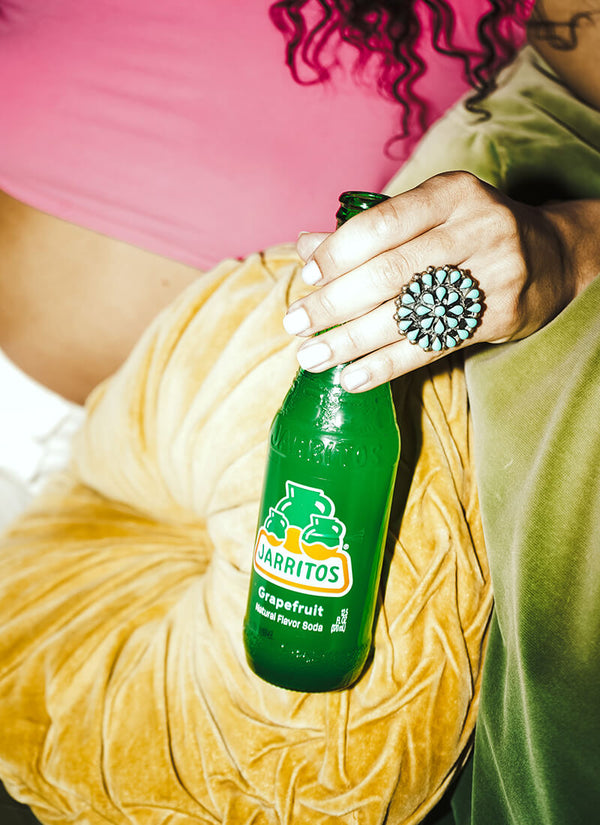 Jarritos Grapefruit soda bottle with fresh grapefruit