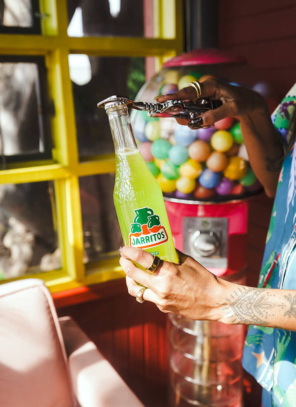 Jarritos Lime soda bottle with fresh limes
