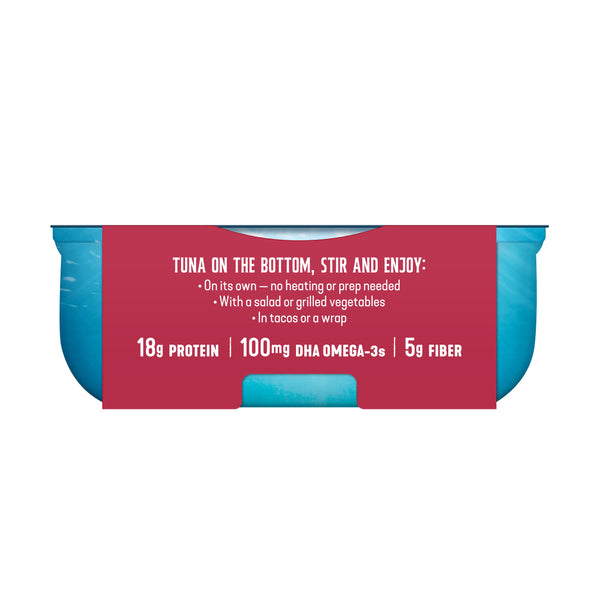 A single can of tuna on a plain white background, shown from the front with a red label and blue sides. The label reads: 'TUNA ON THE BOTTOM, STIR AND ENJOY: 18g PROTEIN | 100MG DHA OMEGA-3s | 5g FIBER'.