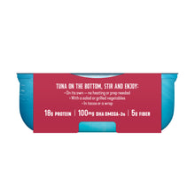 A single can of tuna on a plain white background, shown from the front with a red label and blue sides. The label reads: 'TUNA ON THE BOTTOM, STIR AND ENJOY: 18g PROTEIN | 100MG DHA OMEGA-3s | 5g FIBER'.