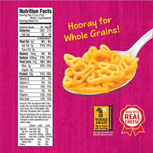 A close-up of a cheese sauce pasta on a spoon against a bright pink background, with a Nutrition Facts panel, the text 'Hooray for Whole Grains!', and a 'Made with Real Cheese' badge.