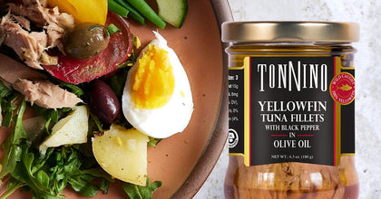 Jar of Tonnino Yellowfin Tuna Fillets with a salad in the background