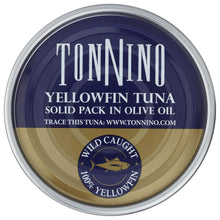 A round metal tin of Tonnino Yellowfin Tuna solid pack in olive oil, featuring a navy blue top half with white text and a gold bottom half, on a white background.