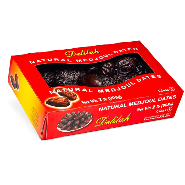 A red and yellow box of Delilah Natural Medjoul Dates, showing a clear window with dark brown dates inside, on a white background.