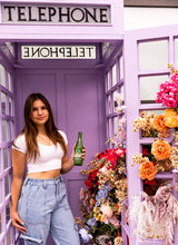 Jarritos Grapefruit Natural Flavor Soda 12.5 fl oz - woman purple telephone booth lifestyle