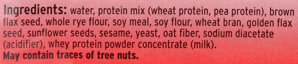 Ingredient list label with wheat protein, flax seed, rye, soy, oat fiber, sesame, sunflower seeds.