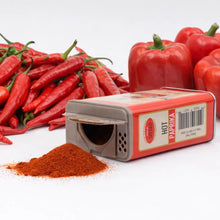 Hot paprika spice in red tin with fresh red chili peppers and bell peppers, perfect for cooking