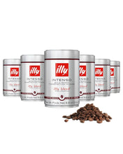 Illy Intenso bold roast coffee cans with whole coffee beans in foreground