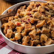 Bowl of homemade bread stuffing with herbs, celery, cranberries, and apples