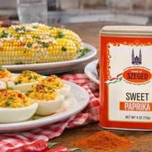 Sweet paprika spice tin with deviled eggs and corn on the cob, perfect for flavorful meals