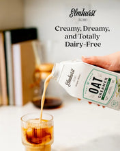 Elmhurst Oat Creamer being poured into iced coffee, dairy-free plant-based unsweetened creamer