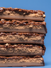 Barebells Nutty Peanut bar cross section showing roasted peanut pieces and chocolate coating