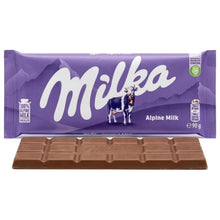 Milka Alpine Milk chocolate bar in purple packaging with a cow and milk chocolate pieces