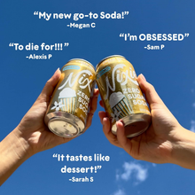 Hands holding Nixie zero sugar soda cans with positive customer reviews against a blue sky.