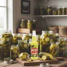 Pickle flavored soda bottle surrounded by jars of pickles on rustic wooden table