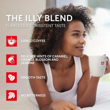 Woman enjoying a cup of Illy blend coffee, highlighting smooth, caramel and floral notes, no bitterness.