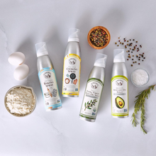 Various cooking oil sprays with eggs, flour, pepper, salt, and rosemary on kitchen counter
