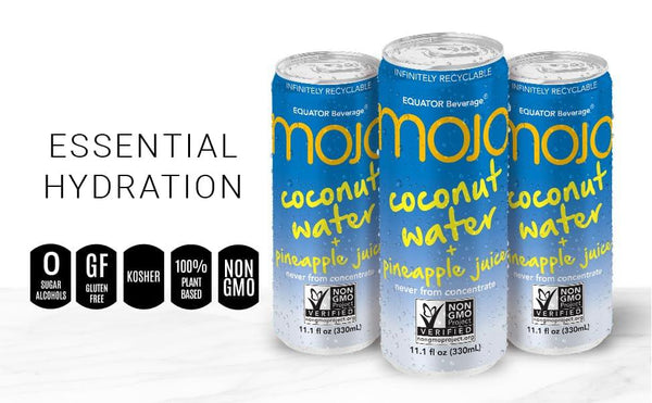 Three cans of coconut water with pineapple juice, labeled non-GMO, gluten free, plant-based.