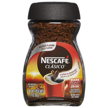 A jar of Nescafe Clásico instant coffee on a plain white background. The packaging features a black lid, a clear jar showing dark brown coffee granules, and a label with red, orange, and white graphics depicting a cup of coffee.