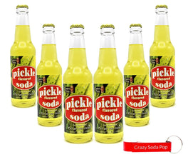 Six bottles of Lester's Fixins Pickle Flavored Soda with red label, yellow liquid, and free 'Crazy Soda Pop' keychain