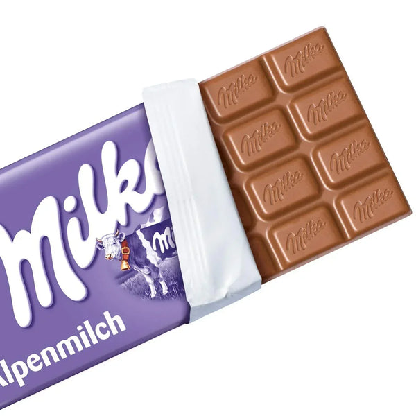 Milka Alpenmilch milk chocolate bar partially unwrapped, showing creamy chocolate squares.